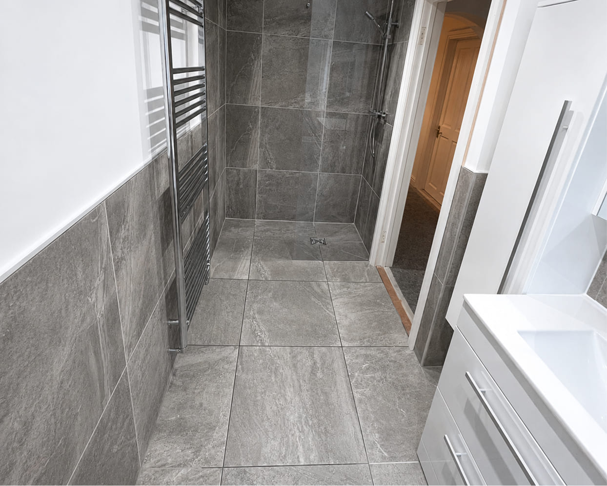 Wet room flooring installation completed by Emberstone Interiors Ltd